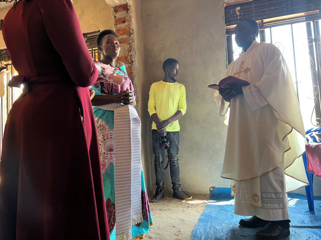 Priest reading during small indoor church service