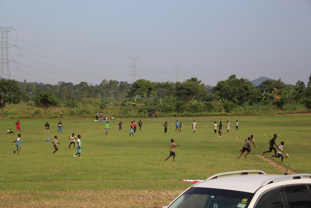 Young players playing soccer on grassy field